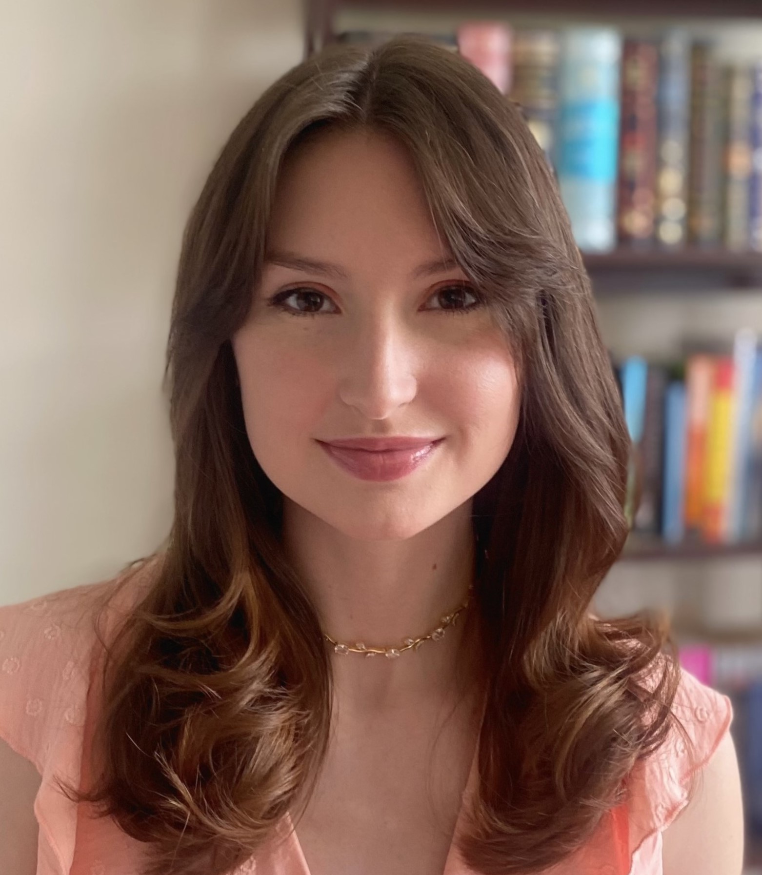 Chloe Wildman smiling with medium auburn hair and a blue blazer.
